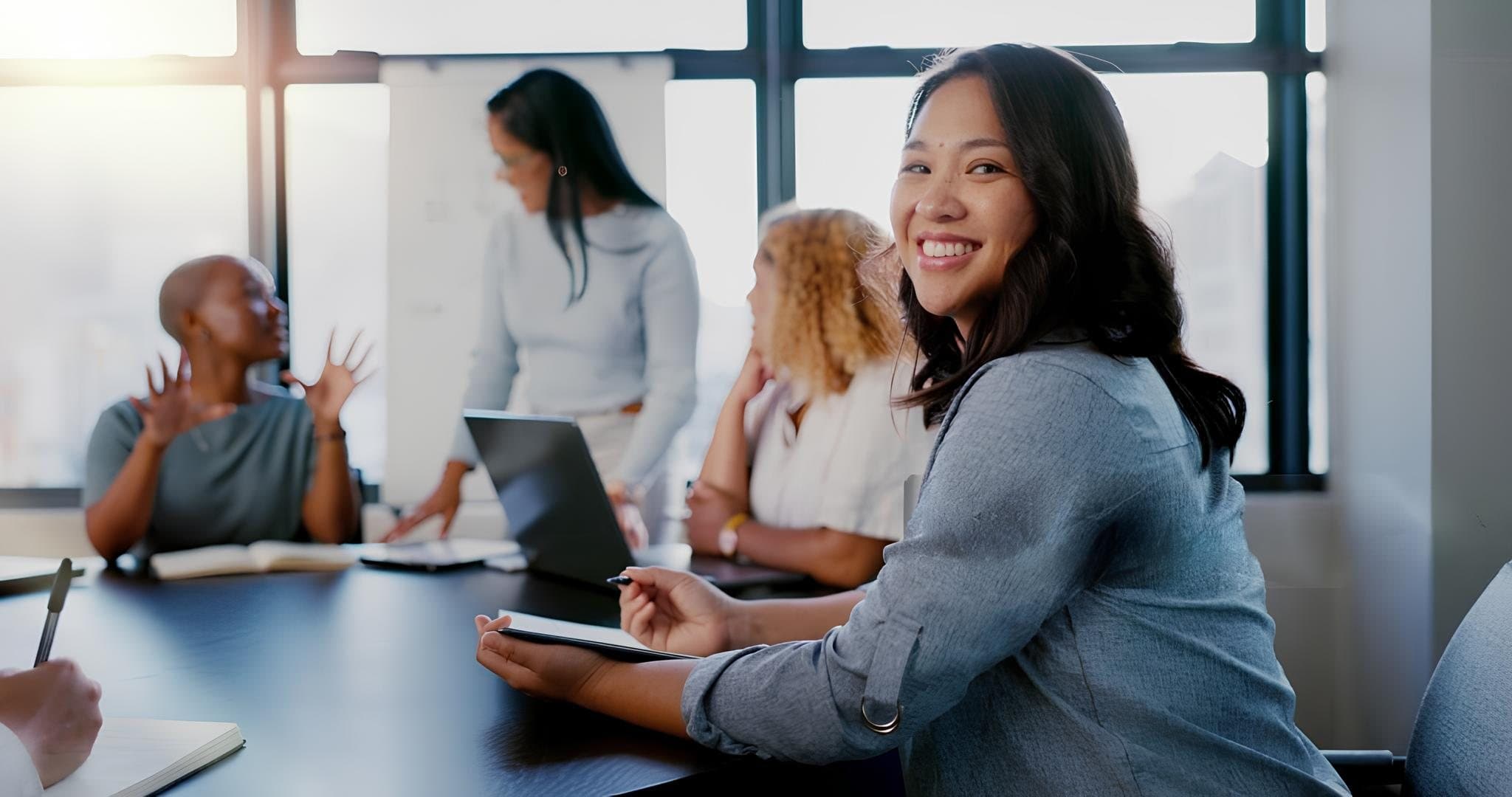 A professional smiling during a team meeting